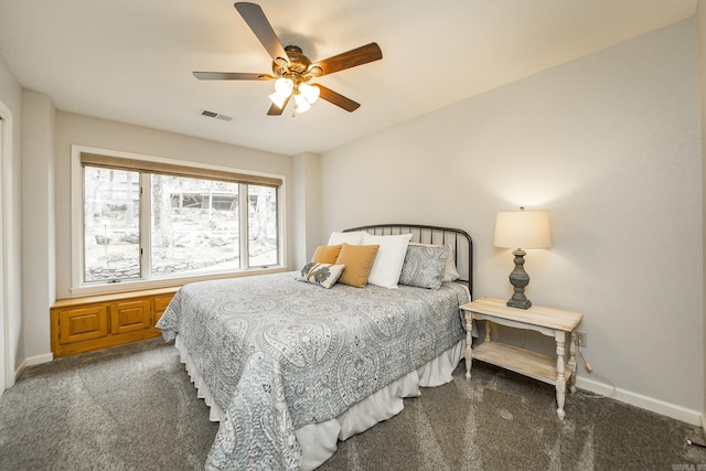 bedroom featuring ceiling fan, dark carpet, visible vents, and baseboards