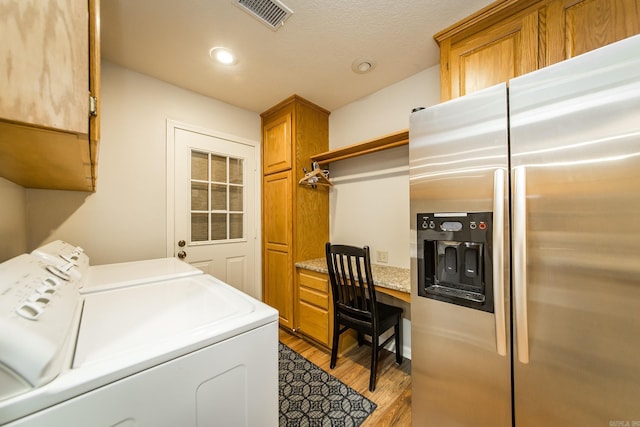 clothes washing area with recessed lighting, visible vents, cabinet space, wood finished floors, and washer and dryer