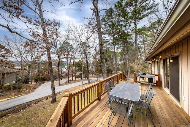 wooden deck featuring outdoor dining area