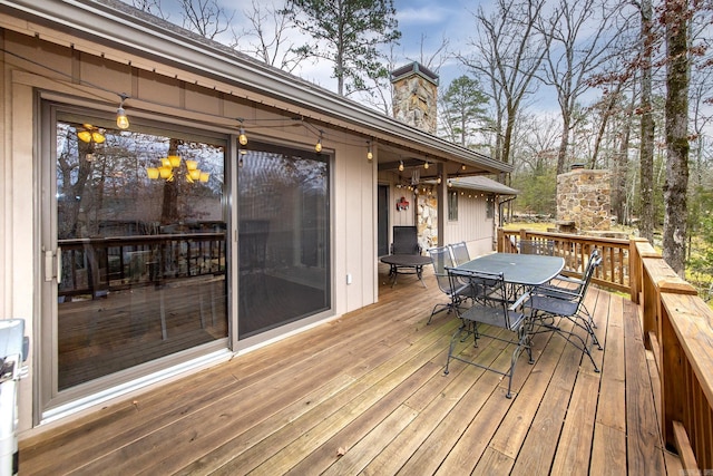 wooden terrace featuring outdoor dining area