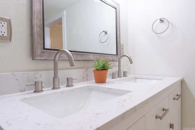 bathroom featuring a sink and double vanity