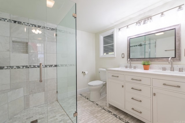 full bathroom featuring double vanity, toilet, tile patterned flooring, a shower stall, and a sink