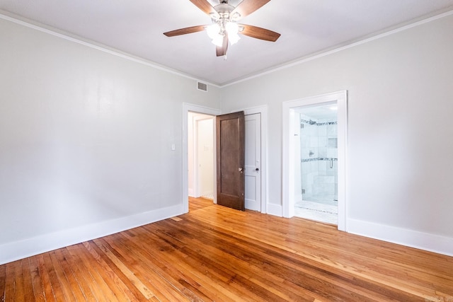 empty room featuring light wood-style floors, crown molding, baseboards, and a ceiling fan