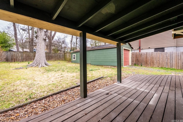 wooden terrace with a fenced backyard, a lawn, and an outdoor structure