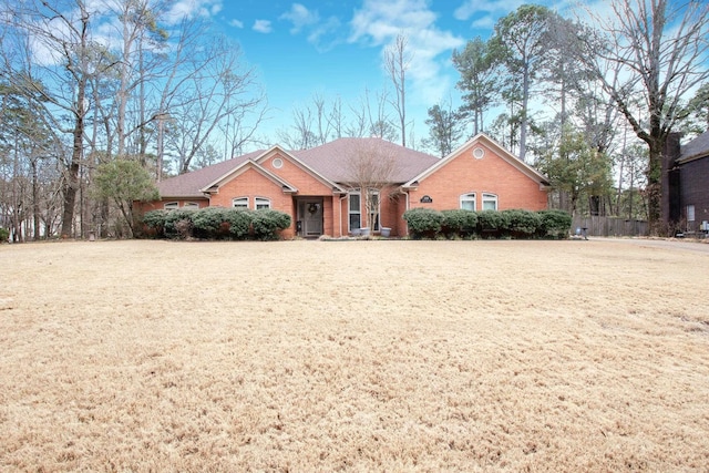 single story home featuring brick siding