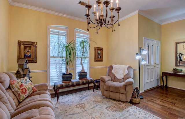 living area featuring a healthy amount of sunlight, crown molding, visible vents, and wood finished floors