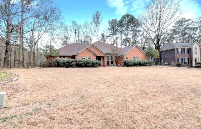 ranch-style house with brick siding and a front lawn