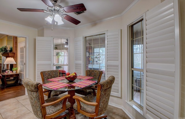 dining room featuring ceiling fan, crown molding, and light tile patterned floors