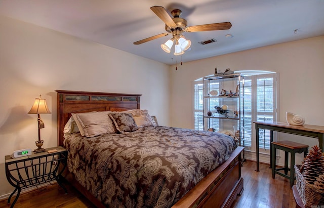 bedroom featuring ceiling fan, hardwood / wood-style floors, and visible vents