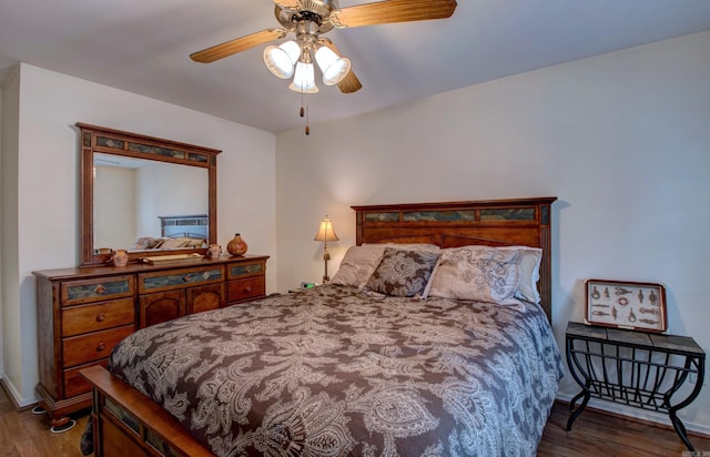 bedroom featuring ceiling fan, wood finished floors, and baseboards