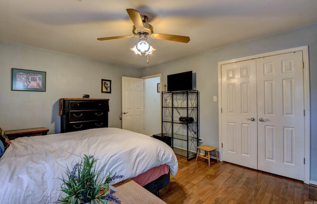 bedroom with a closet, wood finished floors, and a ceiling fan