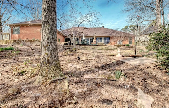 rear view of house with brick siding