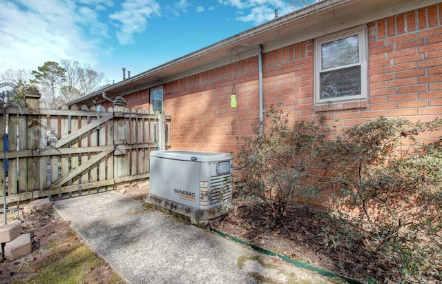 view of property exterior featuring a gate and brick siding