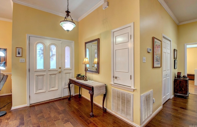 entryway featuring wood-type flooring, visible vents, crown molding, and baseboards