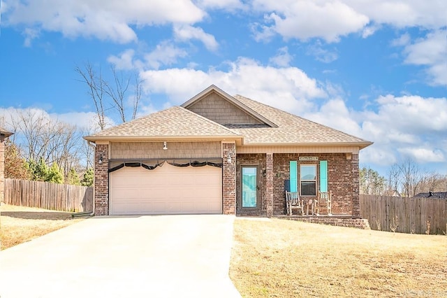 view of front of property featuring a garage, concrete driveway, brick siding, and fence