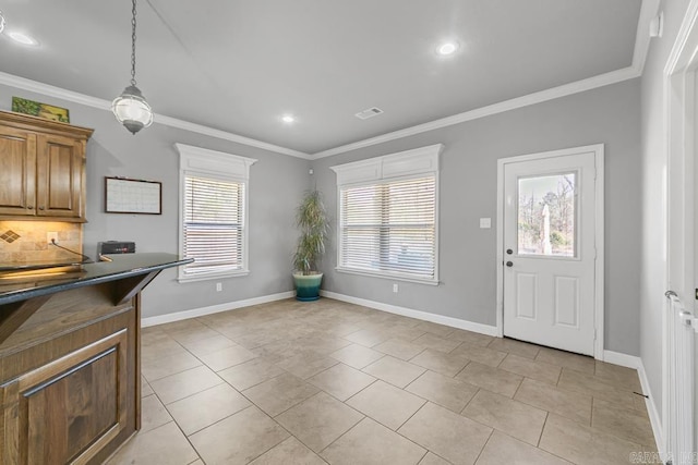 kitchen with dark countertops, tasteful backsplash, ornamental molding, and baseboards