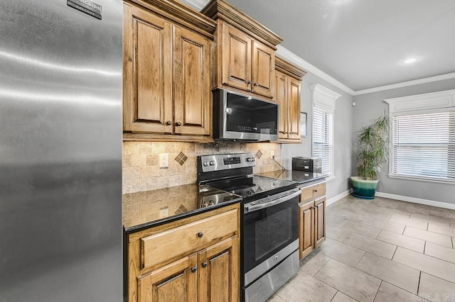 kitchen with stainless steel appliances, dark countertops, tasteful backsplash, ornamental molding, and light tile patterned flooring