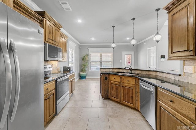 kitchen featuring brown cabinetry, appliances with stainless steel finishes, a sink, backsplash, and light tile patterned flooring