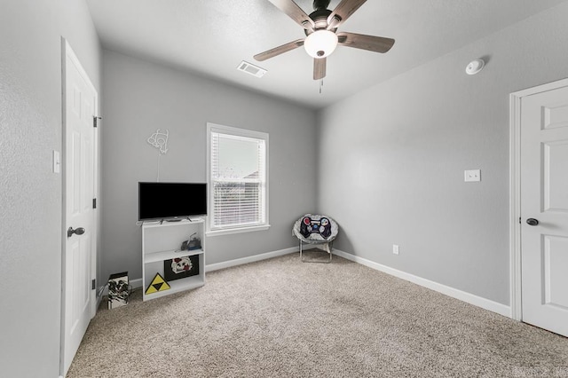interior space with carpet floors, visible vents, ceiling fan, and baseboards