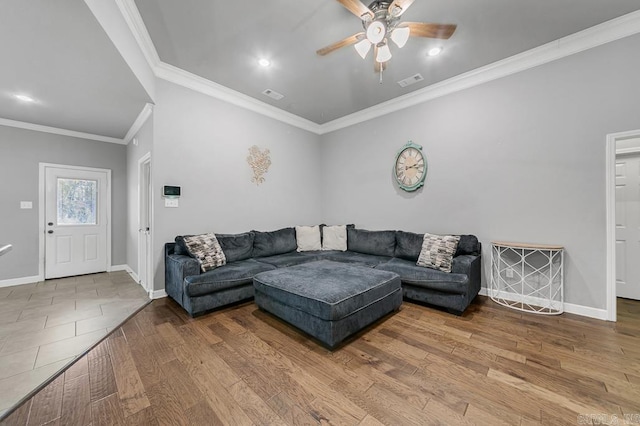 living area with wood finished floors, visible vents, and baseboards