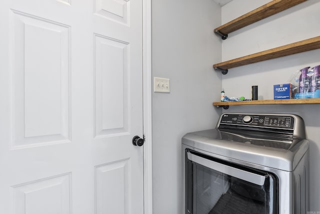 washroom with laundry area and washer / clothes dryer