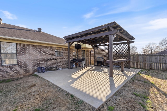 view of patio featuring grilling area and fence