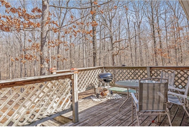 wooden deck featuring a grill