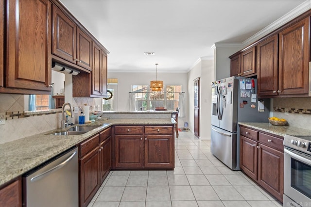 kitchen featuring light tile patterned floors, appliances with stainless steel finishes, ornamental molding, a peninsula, and a sink