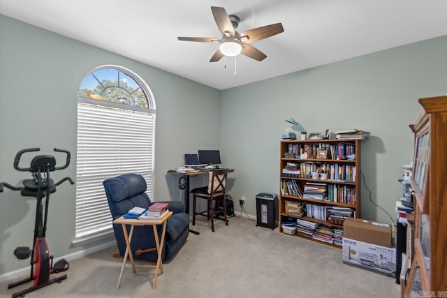 home office with carpet floors, ceiling fan, and baseboards