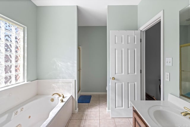 full bathroom featuring a wealth of natural light, a garden tub, vanity, and tile patterned floors