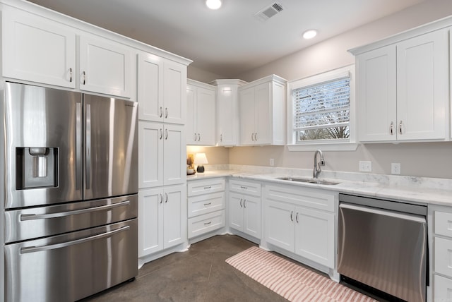 kitchen featuring recessed lighting, visible vents, appliances with stainless steel finishes, white cabinetry, and a sink