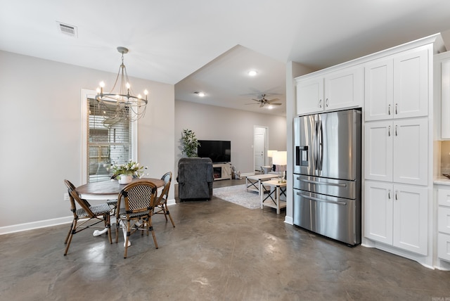 dining space with baseboards, finished concrete floors, visible vents, and ceiling fan with notable chandelier