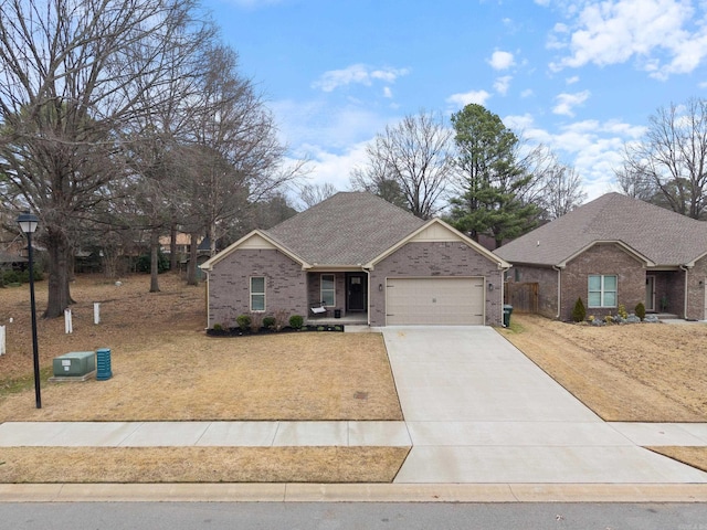 single story home with a garage, a shingled roof, concrete driveway, and brick siding