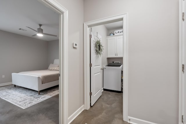 corridor with washer / clothes dryer, visible vents, concrete floors, and baseboards