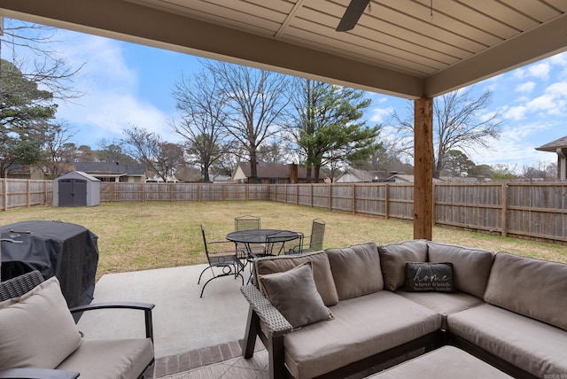 view of patio with a fenced backyard, an outbuilding, a storage unit, outdoor dining area, and an outdoor living space