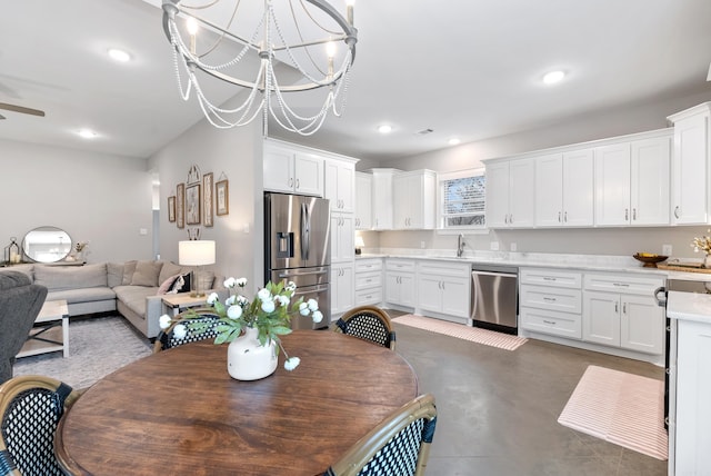 dining space featuring ceiling fan with notable chandelier, finished concrete floors, and recessed lighting