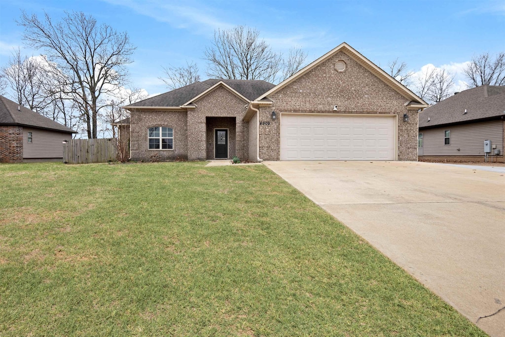 single story home featuring an attached garage, brick siding, fence, concrete driveway, and a front lawn