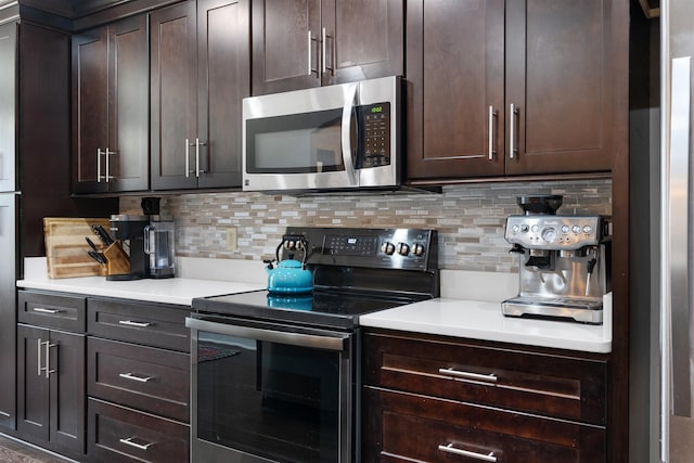 kitchen featuring dark brown cabinets, appliances with stainless steel finishes, and backsplash