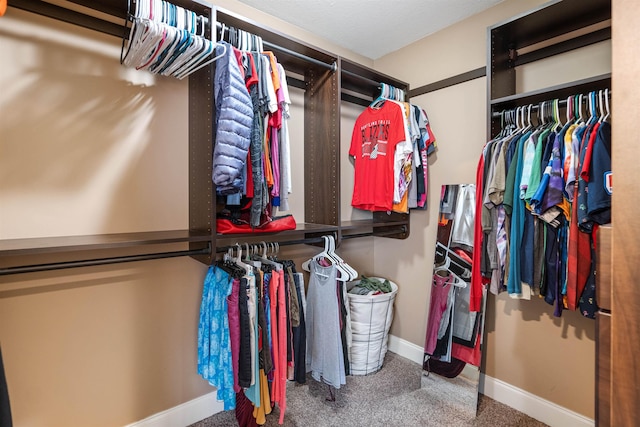 walk in closet featuring carpet floors