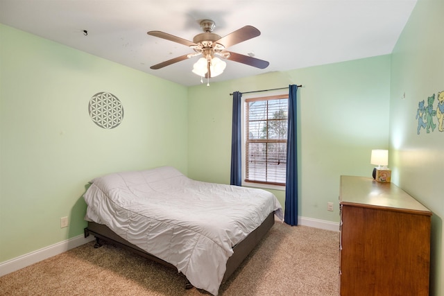 bedroom featuring light colored carpet, ceiling fan, and baseboards