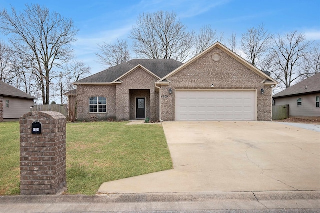 view of front facade featuring a shingled roof, concrete driveway, an attached garage, a front yard, and brick siding