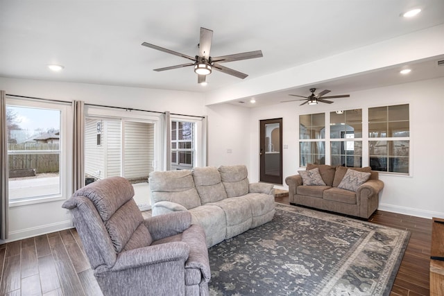 living room with recessed lighting, dark wood finished floors, and baseboards