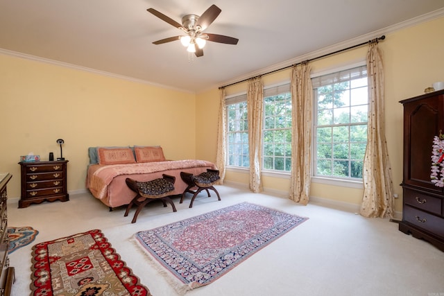 bedroom with light colored carpet, crown molding, baseboards, and ceiling fan