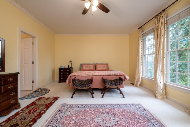 carpeted bedroom featuring baseboards, ornamental molding, and ceiling fan