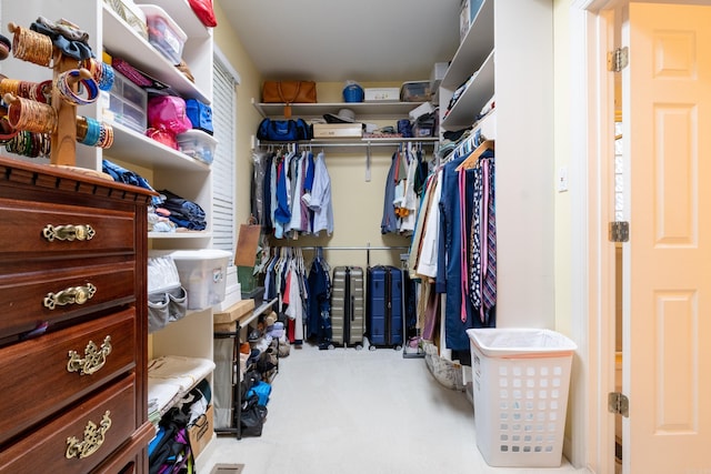 walk in closet featuring carpet flooring