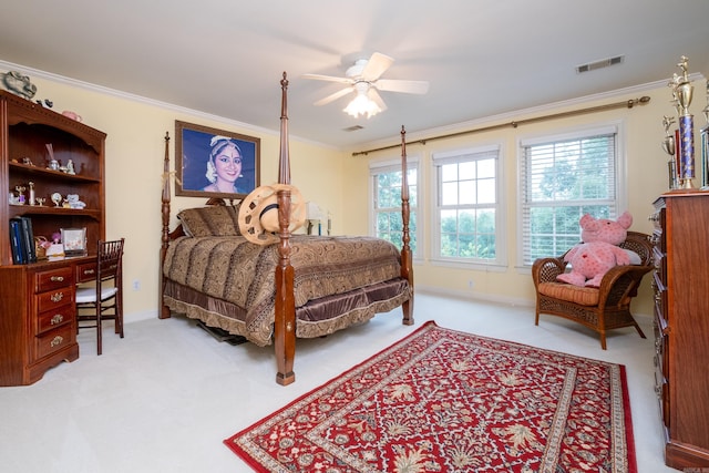 carpeted bedroom with baseboards, ceiling fan, visible vents, and crown molding