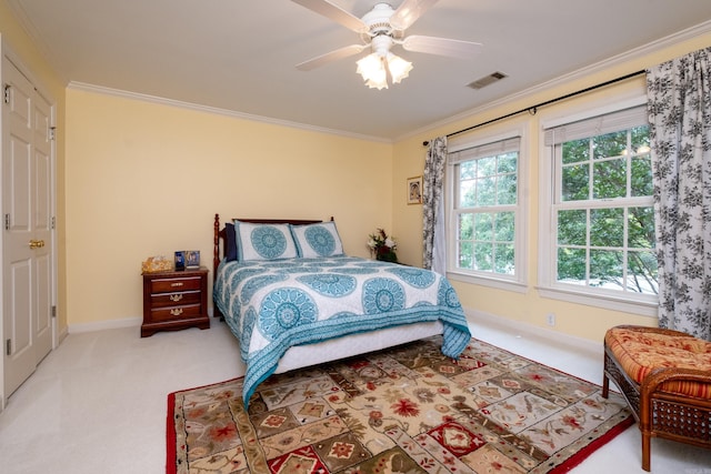 bedroom with light colored carpet, crown molding, visible vents, and baseboards