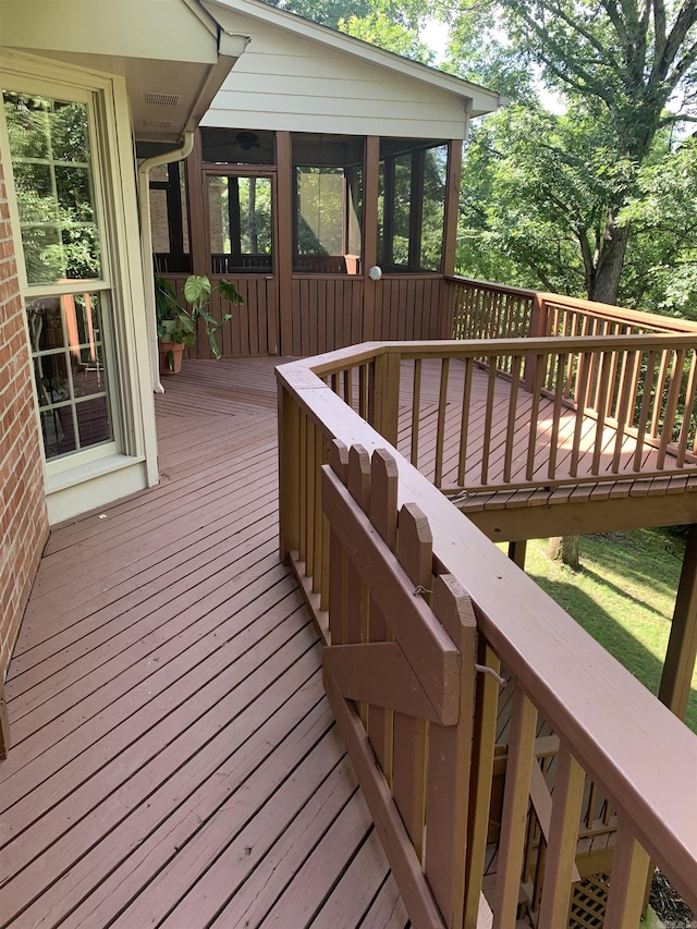 wooden terrace featuring a sunroom