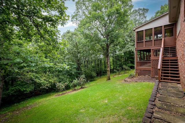 view of yard featuring stairway and a sunroom