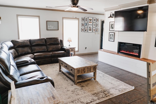 living room with a fireplace, visible vents, ornamental molding, a ceiling fan, and baseboards